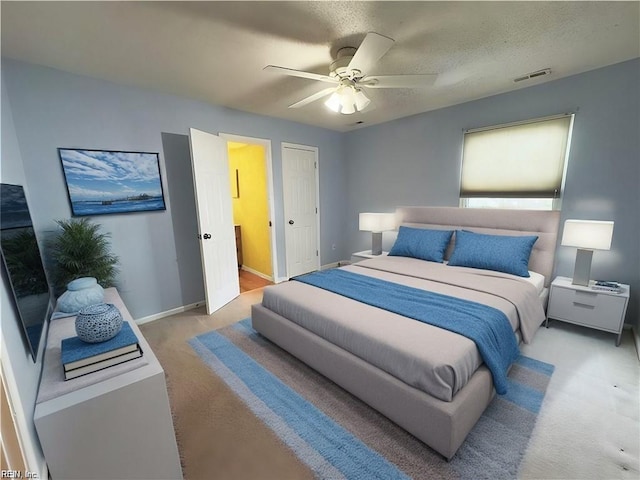 bedroom featuring a ceiling fan, visible vents, and baseboards