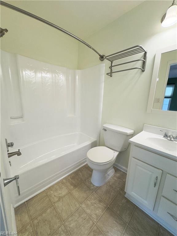 full bath featuring toilet, bathtub / shower combination, baseboards, and vanity