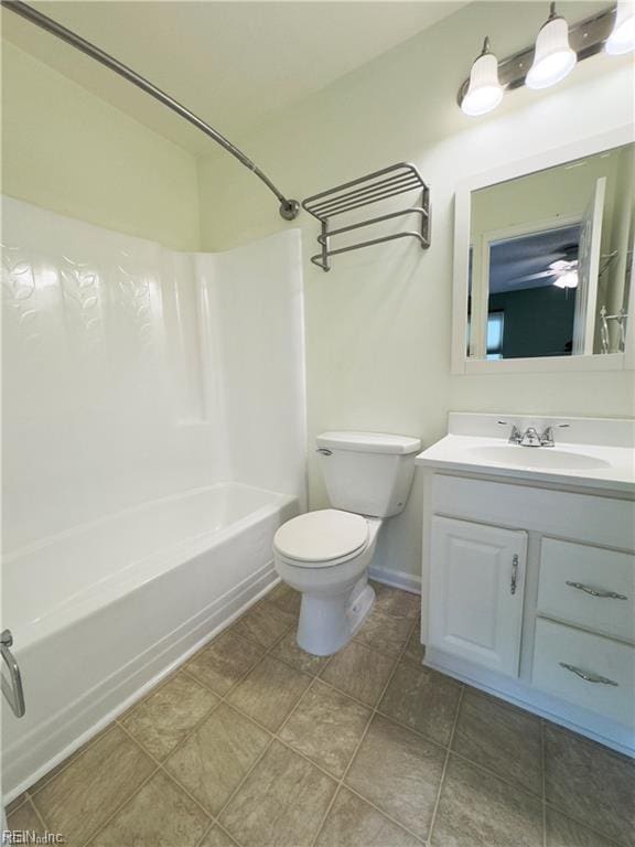 full bath featuring shower / bath combination, toilet, vanity, baseboards, and tile patterned floors