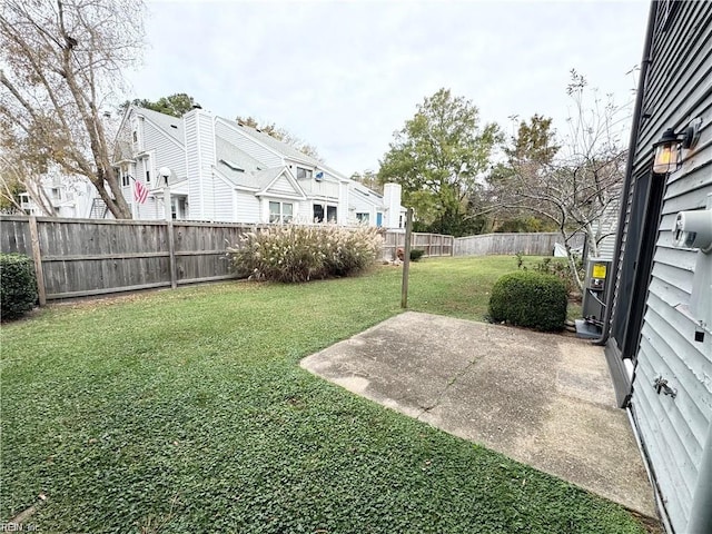 view of yard with a fenced backyard, a residential view, and a patio