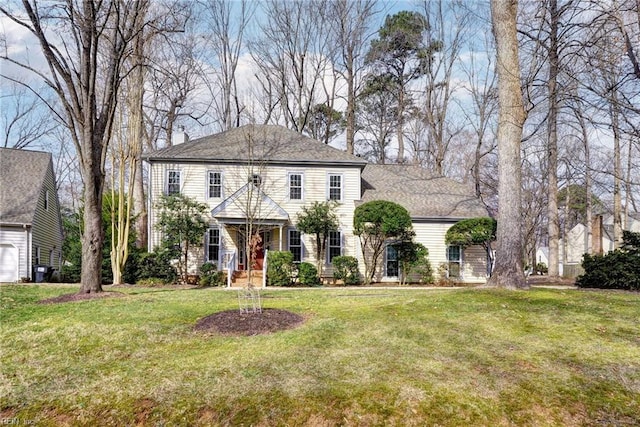 colonial inspired home with a front lawn