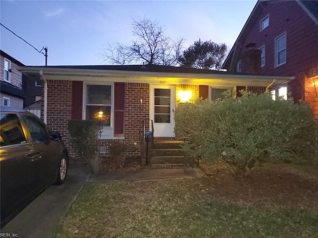 view of front of house featuring entry steps and brick siding