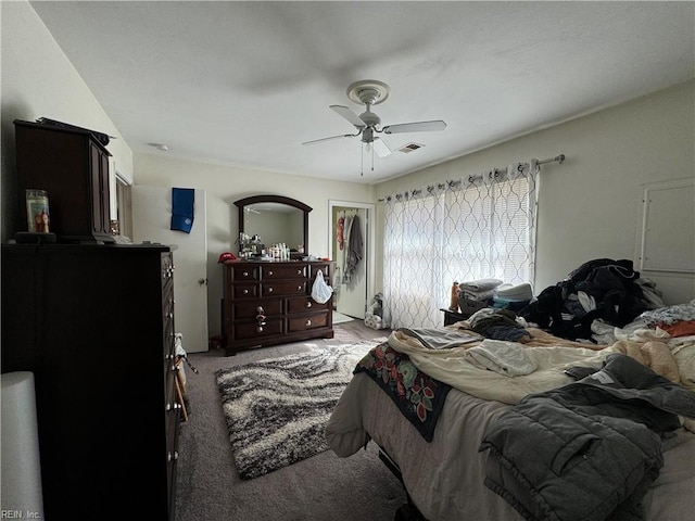 carpeted bedroom with visible vents and a ceiling fan