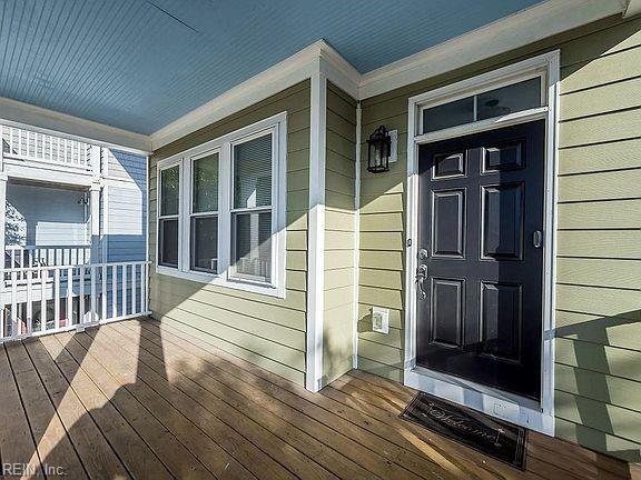 view of exterior entry with a porch