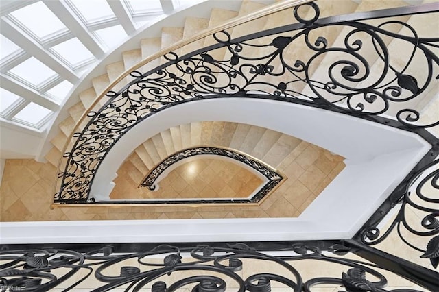 stairs featuring a skylight