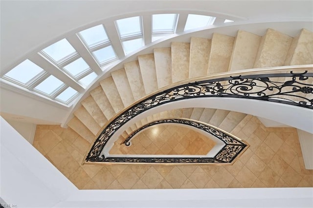 stairway featuring a skylight