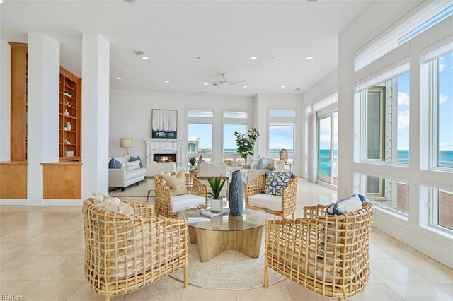 interior space featuring plenty of natural light, a high end fireplace, and a ceiling fan