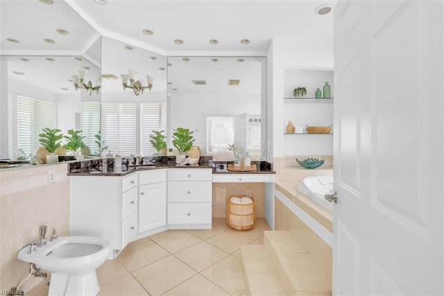 bathroom featuring a garden tub, tile patterned flooring, a bidet, and vanity