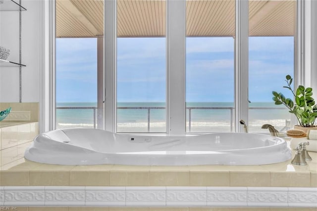 bathroom with a water view and a garden tub