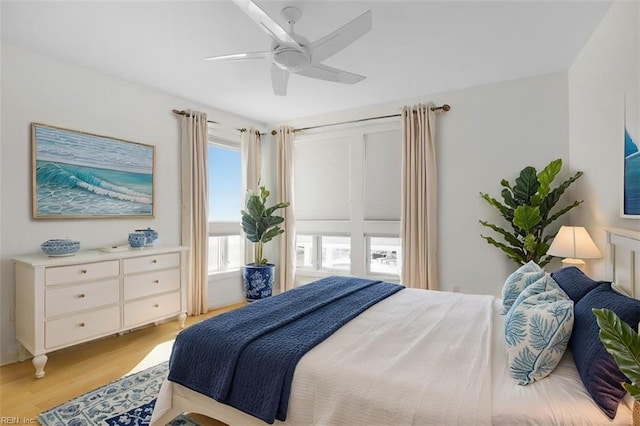 bedroom with light wood-style floors and a ceiling fan