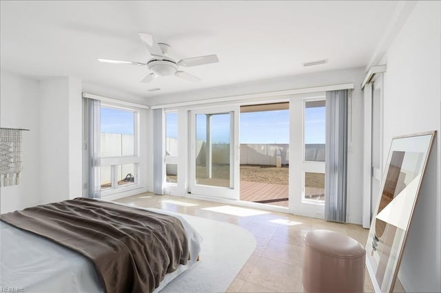 bedroom with access to exterior, multiple windows, visible vents, and a ceiling fan