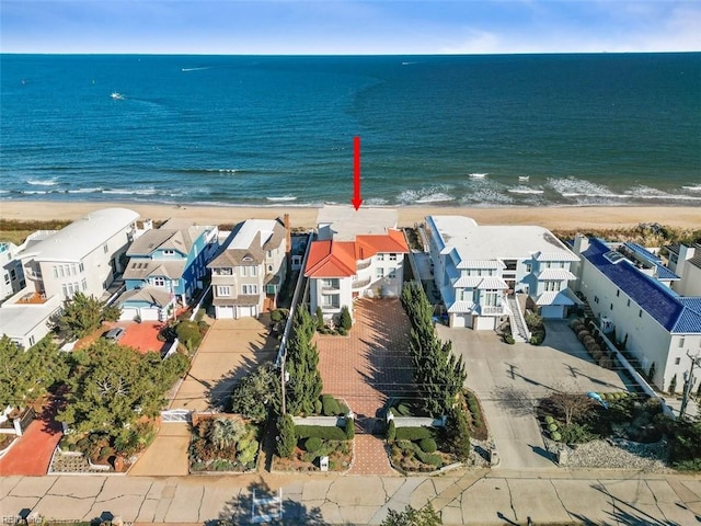 aerial view featuring a water view, a residential view, and a view of the beach