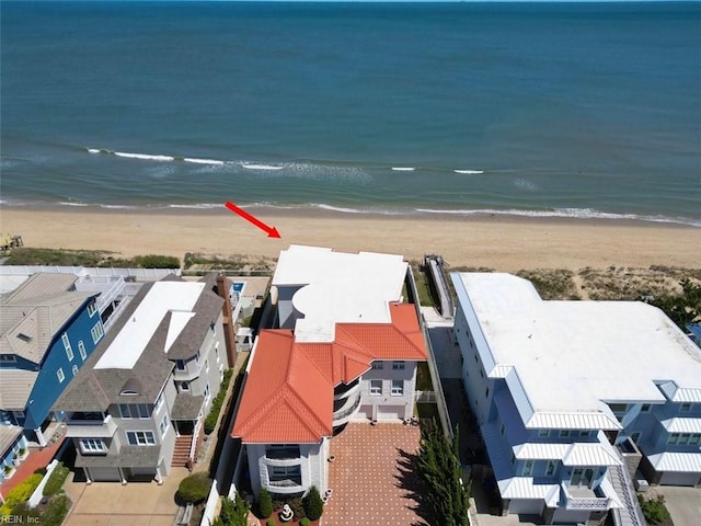 birds eye view of property with a view of the beach and a water view