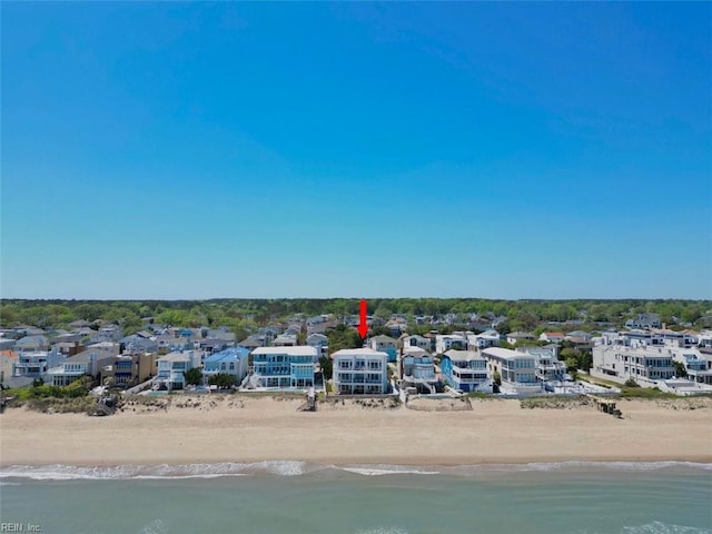 birds eye view of property with a water view, a residential view, and a view of the beach