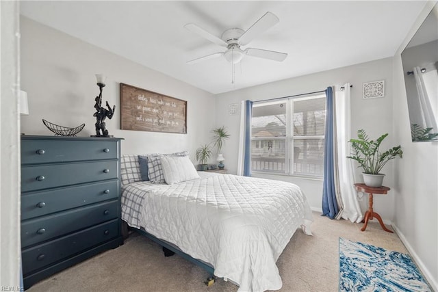 carpeted bedroom featuring ceiling fan and baseboards