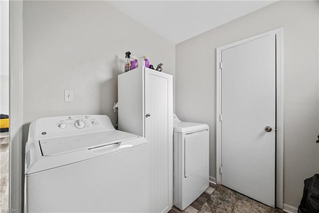 washroom with cabinet space and washer and dryer