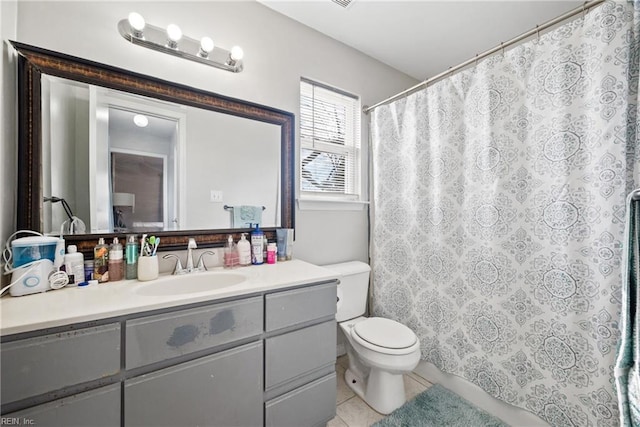 bathroom featuring vanity, curtained shower, tile patterned flooring, and toilet