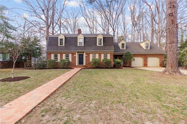 colonial inspired home featuring a garage, a front yard, a gambrel roof, and brick siding