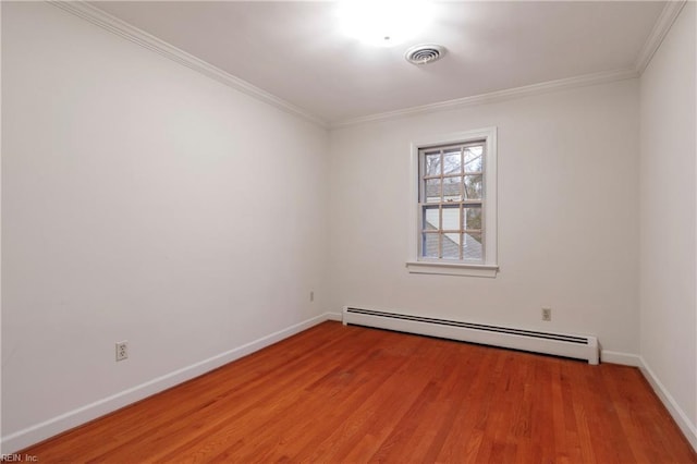 empty room with light wood-style flooring, visible vents, baseboard heating, and crown molding