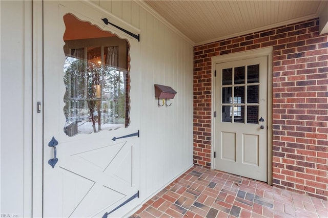 doorway to property with brick siding