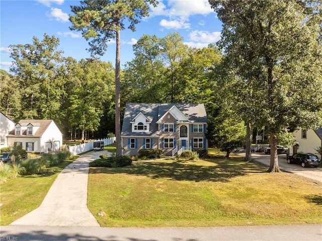 view of front of home with fence and a front lawn