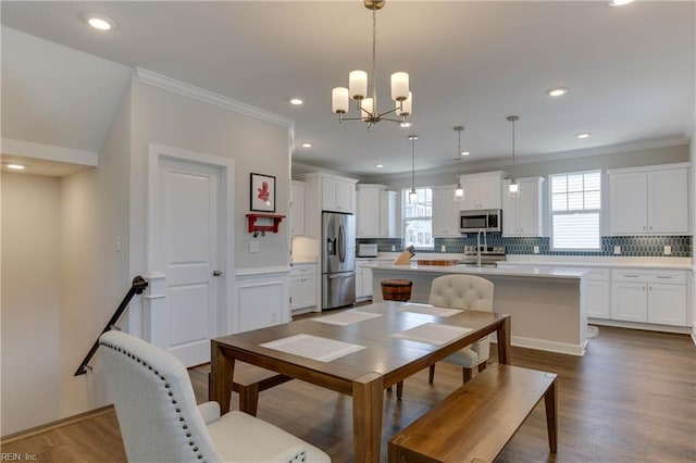 dining area featuring recessed lighting, crown molding, a wealth of natural light, and wood finished floors