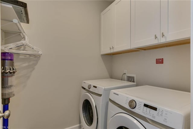 laundry area with cabinet space and washing machine and clothes dryer