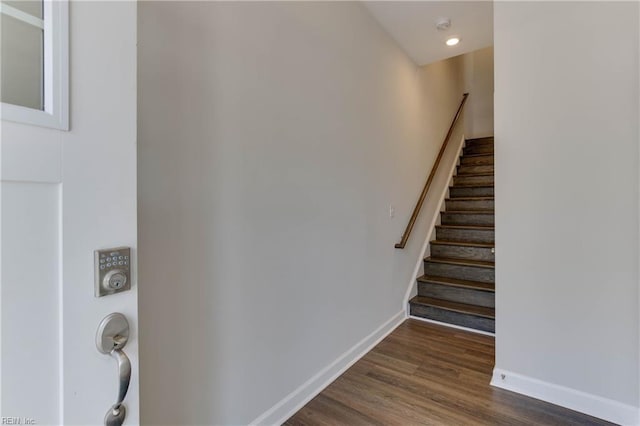 stairs with baseboards and wood finished floors