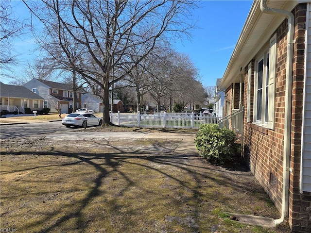 view of yard with a residential view and fence