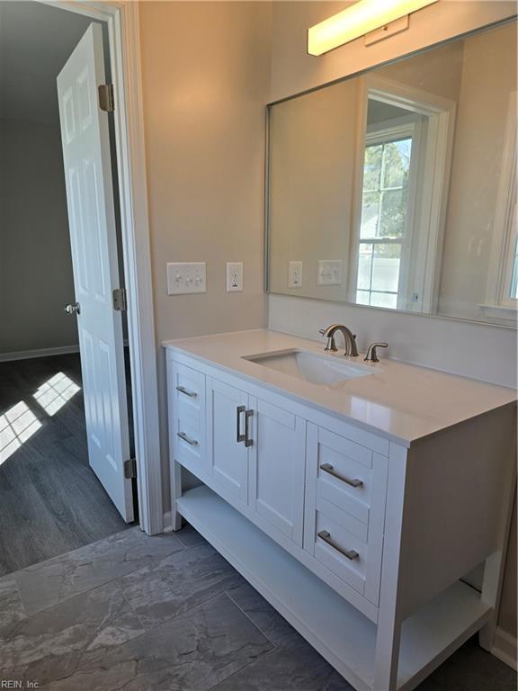 bathroom featuring baseboards and vanity