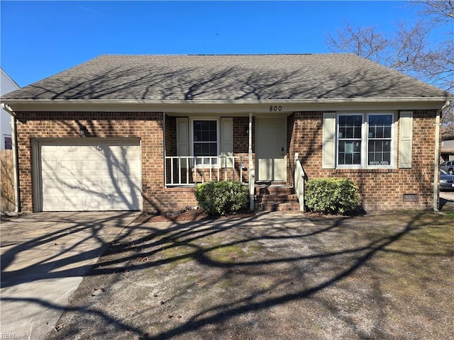 view of front facade featuring a shingled roof, concrete driveway, brick siding, and an attached garage