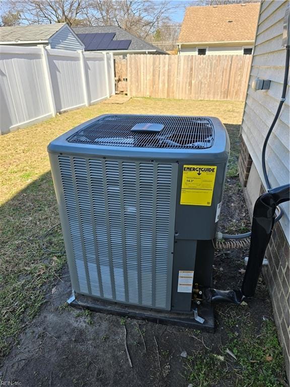 details featuring fence and central AC unit