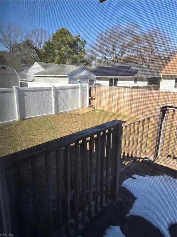 wooden deck with a yard and a fenced backyard