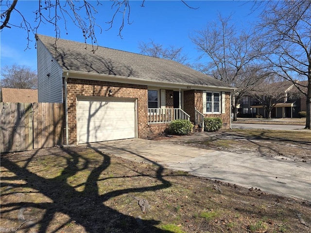 view of front of property featuring concrete driveway, roof with shingles, an attached garage, fence, and brick siding