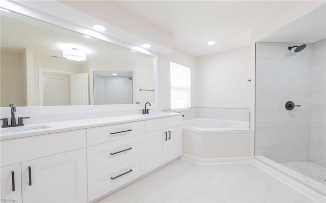 bathroom featuring double vanity, a bath, a sink, and tiled shower