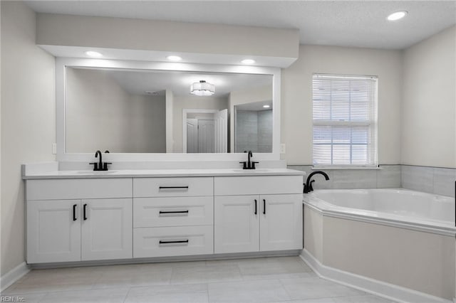 bathroom featuring a garden tub, a sink, and double vanity