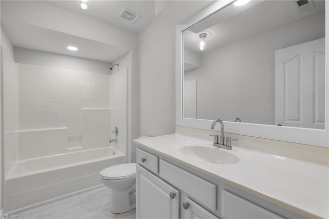 bathroom featuring  shower combination, visible vents, vanity, and toilet