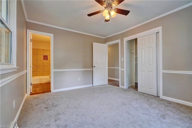 unfurnished bedroom featuring carpet floors, a closet, ornamental molding, and baseboards