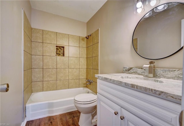 full bath featuring  shower combination, vanity, toilet, and wood finished floors