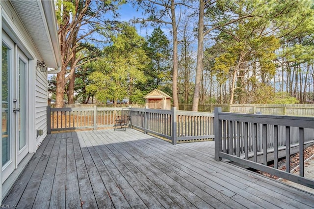 wooden terrace with an outbuilding and a fenced backyard