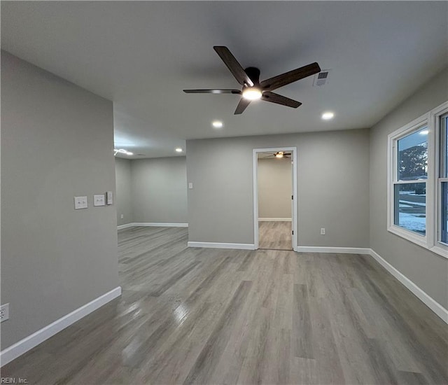 empty room with visible vents, baseboards, and wood finished floors