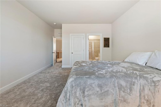 bedroom with carpet flooring, ensuite bath, and baseboards