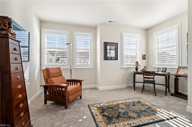 living area with carpet, visible vents, and baseboards