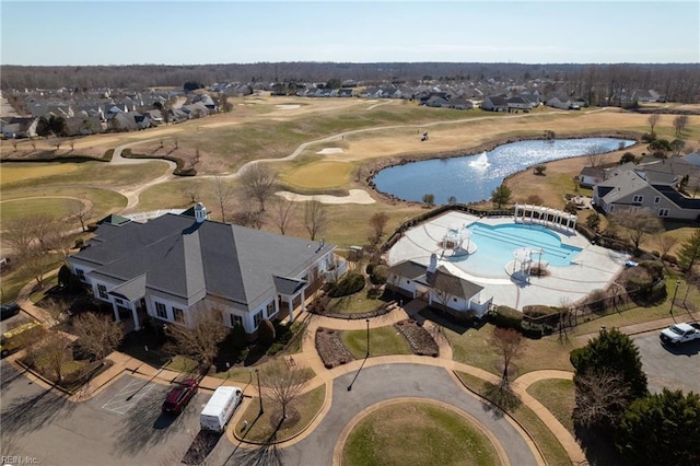 birds eye view of property with golf course view, a water view, and a residential view