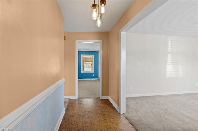 hall with an upstairs landing and baseboards