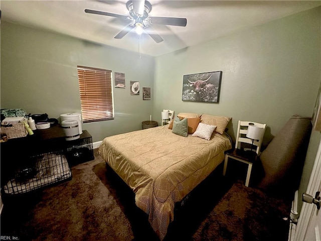 carpeted bedroom featuring a ceiling fan and baseboards