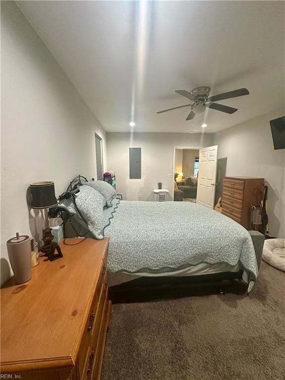 bedroom with a ceiling fan, carpet, and electric panel