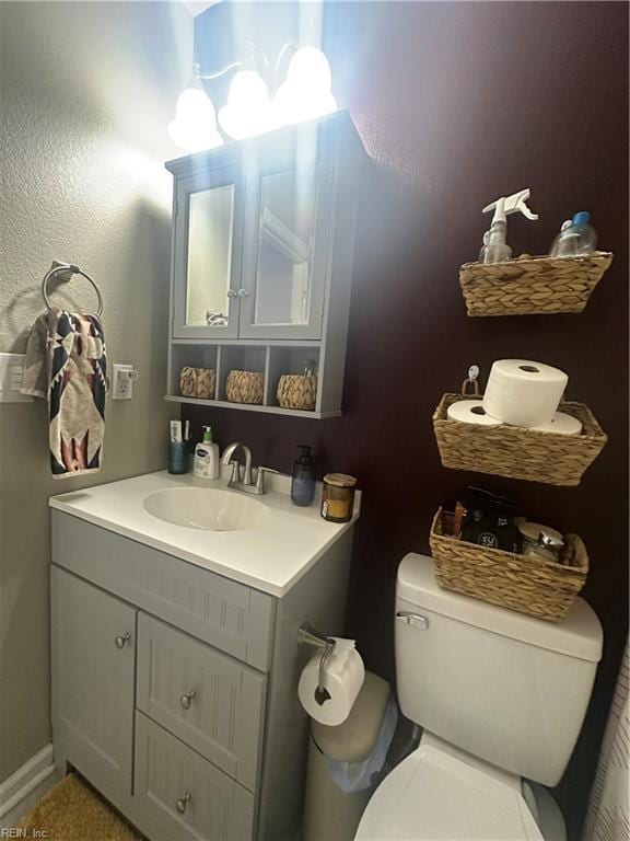 half bathroom with vanity and toilet