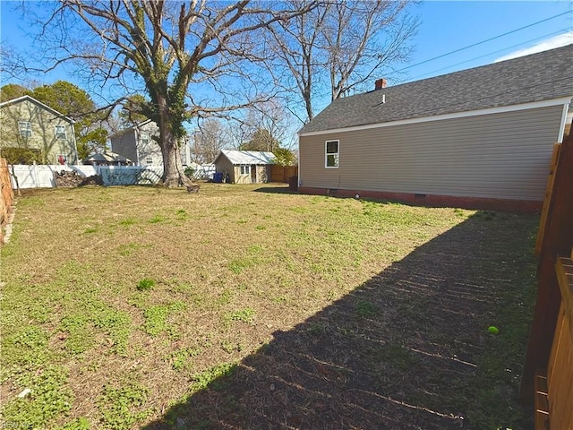 view of yard with an outbuilding and a fenced backyard