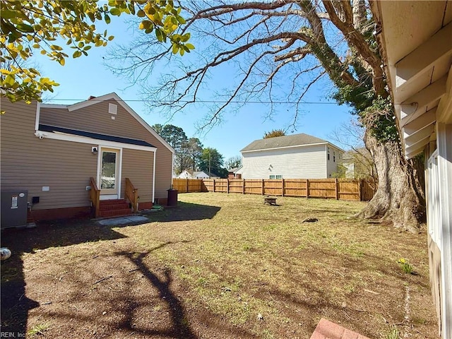 view of yard featuring entry steps, fence private yard, and cooling unit